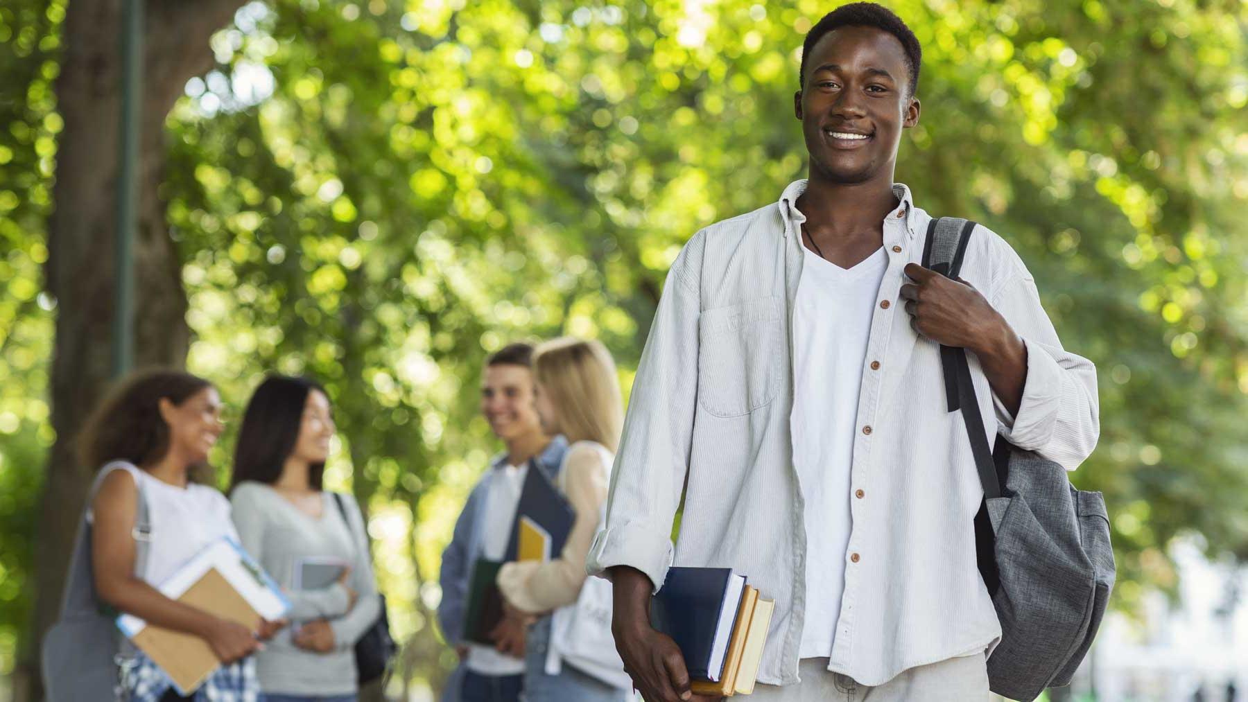 Student with teacher and open book at large table